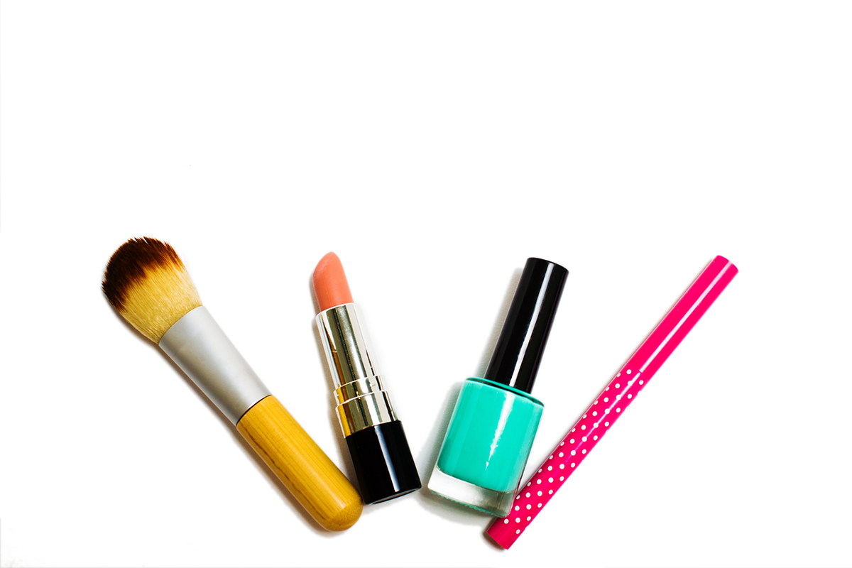 Makeup brush, lipstick, nail polish and a makeup product