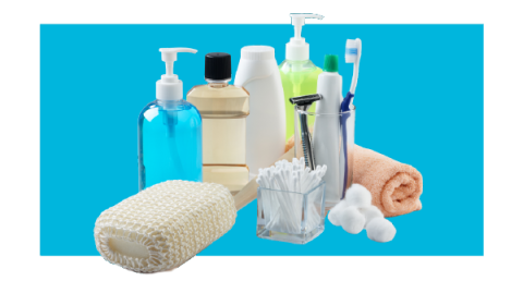 A variety of bathroom items, like soap, loofah and lotion, on a color background